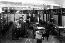 Customers in the Barnsley Co-op jewellery department, South Yorkshire, 1957. Creator: Michael Walters