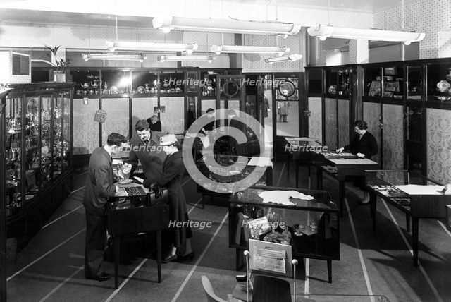 Customers in the Barnsley Co-op jewellery department, South Yorkshire, 1957.   Creator: Michael Walters.