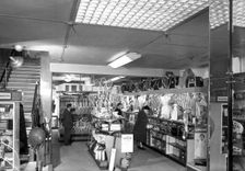Customers in the Barnsley Co-op's sports department, South Yorkshire, 1957. Creator: Michael Walters