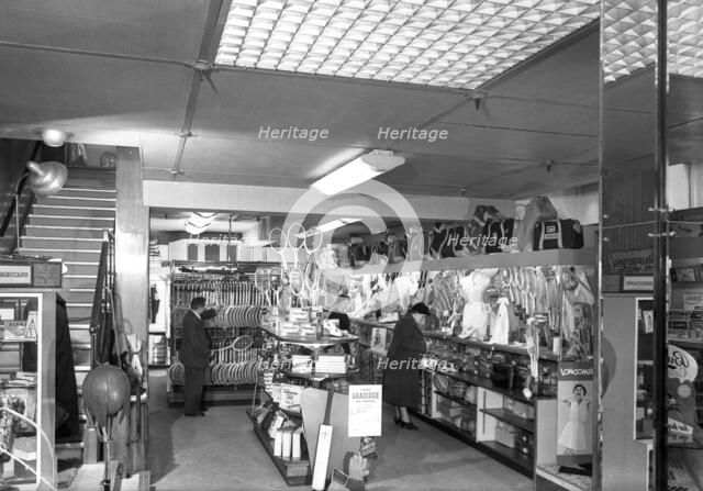 Customers in the Barnsley Co-op's sports department, South Yorkshire, 1957. Artist: Michael Walters