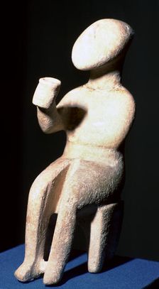 Cycladic marble seated figure holding a cup