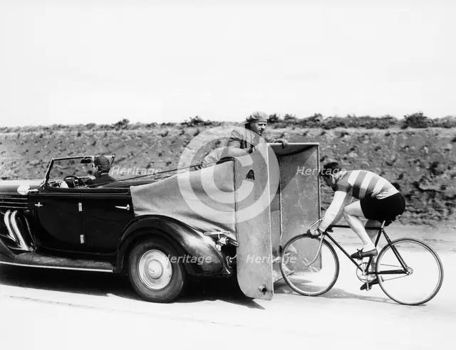 Cyclist training behind an Auburn car, c1935. Artist: Unknown