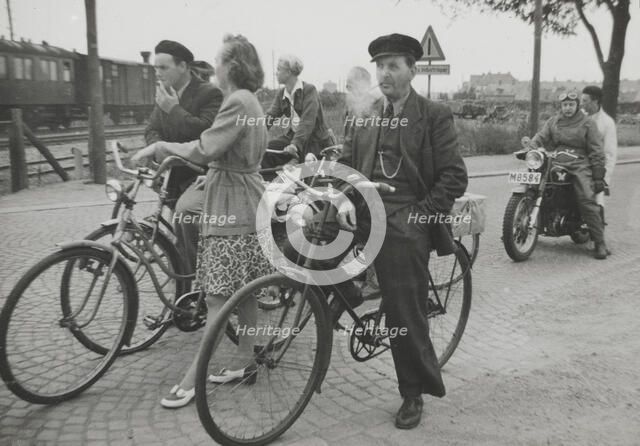 Cyclists by a level crossing, Landskrona, Sweden, 1950. Artist: Unknown