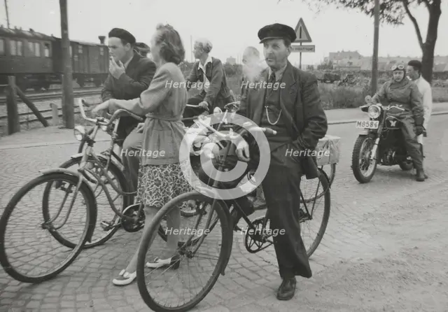 Cyclists by a level crossing, Landskrona, Sweden, 1950.  Creator: Unknown.