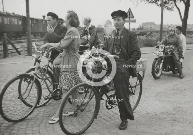 Cyclists by a level crossing, Landskrona, Sweden, 1950.  Creator: Unknown.