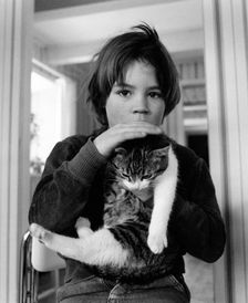 A 5 year old boy with his pet cat. Creator: Unknown
