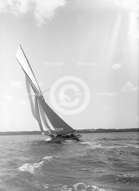 A 15 Metre yacht sailing close-hauled in a good breeze, 1911. Creator: Kirk & Sons of Cowes.