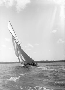 A 15 Metre yacht sailing close-hauled in a good breeze, 1911. Creator: Kirk & Sons of Cowes