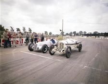 A 1914 and 1937 Grand Prix Mercedes racing cars at the starting line