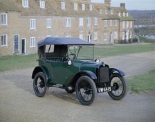A 1929 Austin 7 in front of a row of terraced houses
