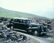 A 1937 Cadillac V16 sedan, photographed among piles of slate