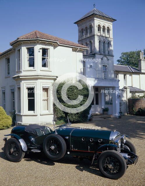 A 1930 Bentley Supercharged outside a house. Artist: Unknown