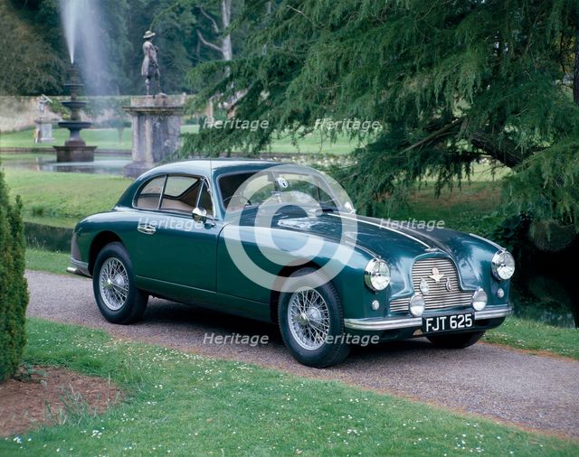 A 1952 Aston Martin DB2 saloon car photographed in a stately garden. Artist: Unknown