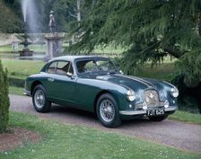 A 1952 Aston Martin DB2 saloon car photographed in a stately garden