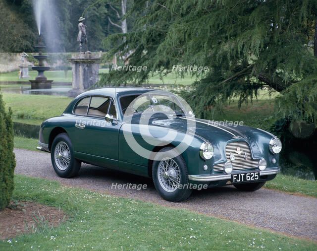 A 1952 Aston Martin DB2 saloon car photographed in a stately garden. Artist: Unknown