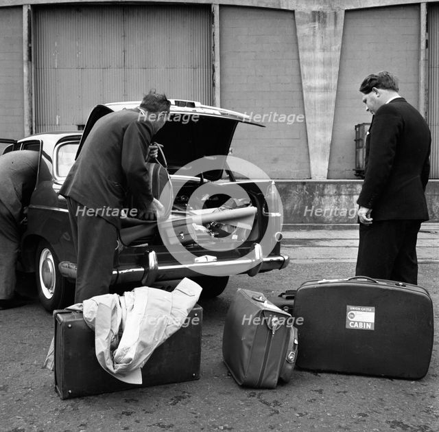 A 1961 Austin Westminster being loaded with luggage on Amsterdam docks, Netherlands 1963. Artist: Michael Walters