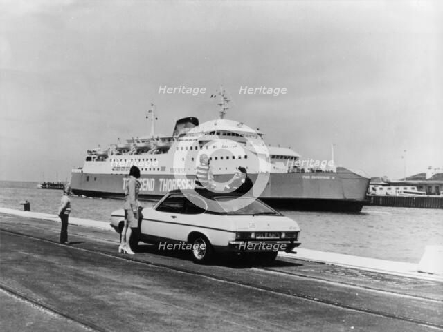 A 1974 Ford Capri on a quay, in front of a Townsend Thoresen car ferry, 1970s. Artist: Unknown