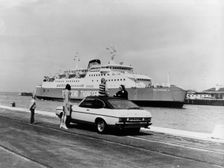 A 1974 Ford Capri on a quay, in front of a Townsend Thoresen car ferry, 1970s