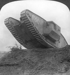 A tank breaking through the wire at Cambrai France, World War I, c1917-c1918. Artist: Realistic Travels Publishers