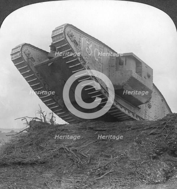 'A tank breaking through the wire at Cambrai', France, World War I, c1917-c1918. Artist: Realistic Travels Publishers