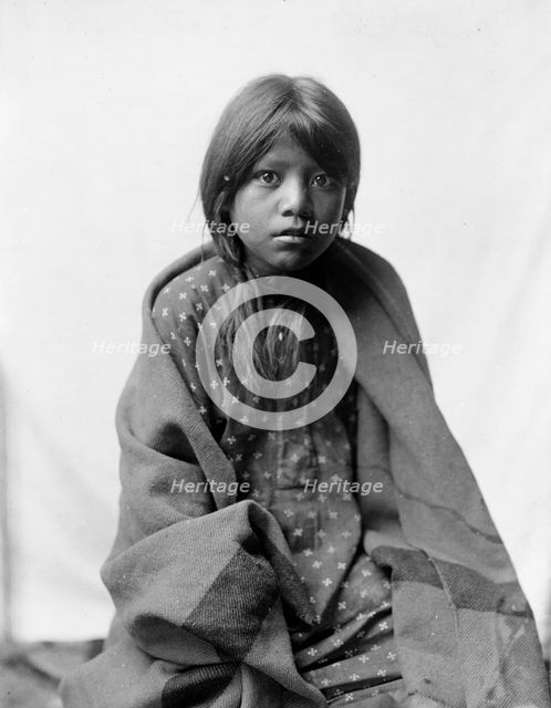 A Taos girl, three-quarter length portrait, seated, facing front, c1905. Creator: Edward Sheriff Curtis.