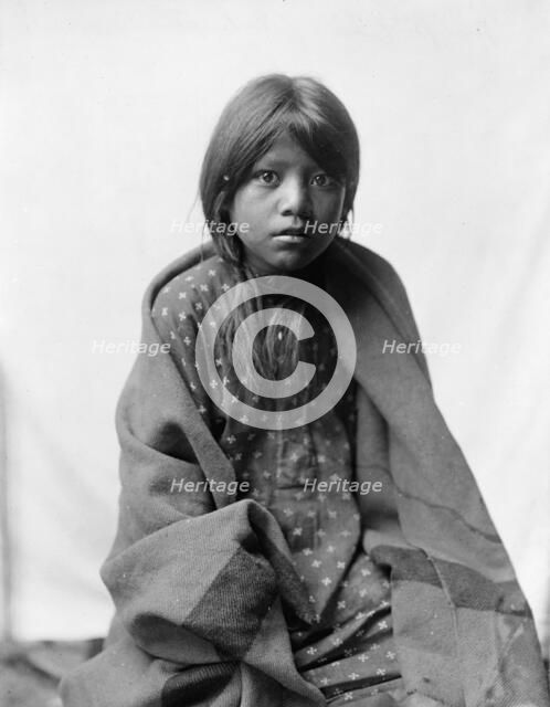 A Taos girl, three-quarter length portrait, seated, facing front, c1905. Creator: Edward Sheriff Curtis.