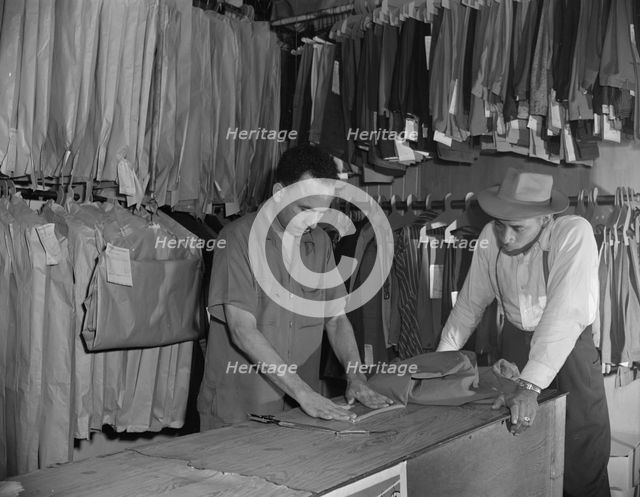 A tailor in Frank's cleaning and pressing establishment altering..., Washington, D.C., 1942. Creator: Gordon Parks.