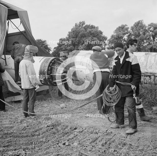 A team of men working on the lining up operation of the Fens gas pipeline, Norfolk, 24/07/1967. Creator: John Laing plc.