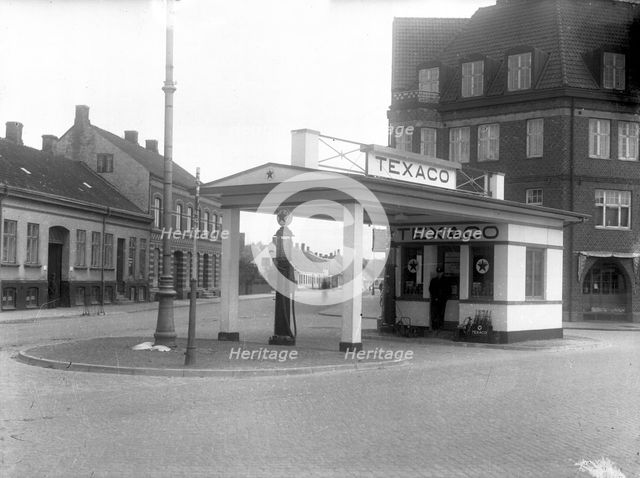 A  Texaco petrol pump in a built-up area, Landskrona, Sweden, 1930 Creator: Unknown.