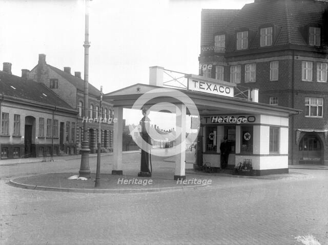 A  Texaco petrol pump in a built-up area, Landskrona, Sweden, 1930 Artist: Unknown
