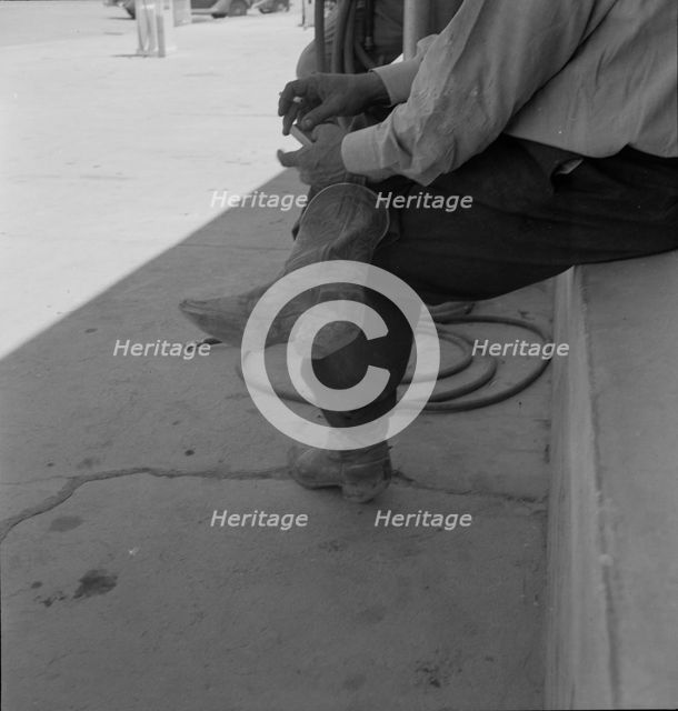 A Texas cattleman is distinguished by the type of boot he wears, Van Horn, Texas, 1937. Creator: Dorothea Lange.