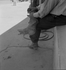 A Texas cattleman is distinguished by the type of boot he wears, Van Horn, Texas, 1937. Creator: Dorothea Lange