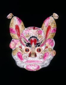 A tiger face mask painted with garish colours, China, 20th century. Creator: Unknown