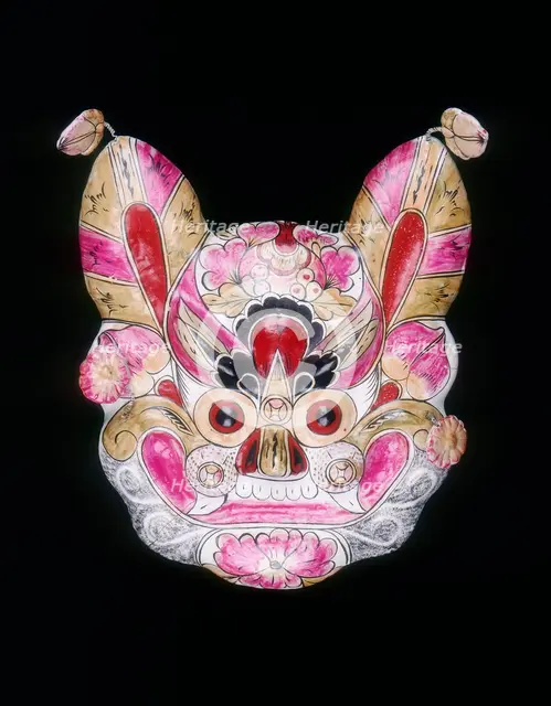 A tiger face mask painted with garish colours, China, 20th century. Creator: Unknown.