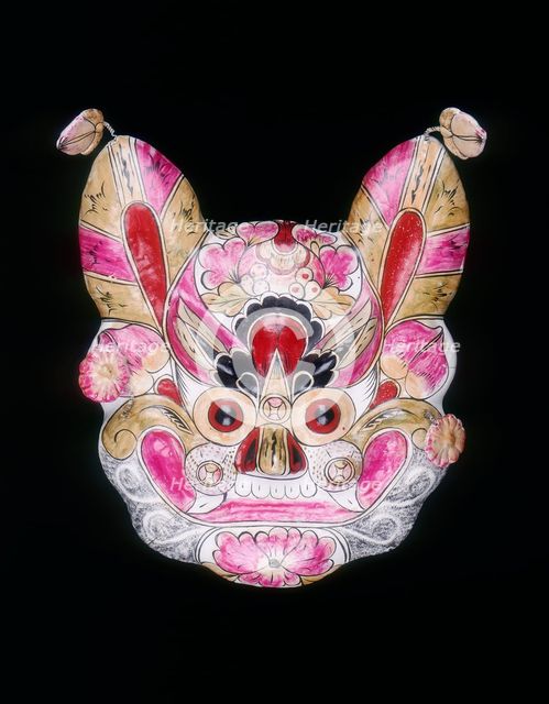 A tiger face mask painted with garish colours, China, 20th century. Creator: Unknown.