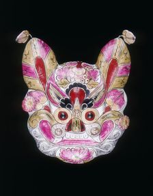 A tiger face mask painted with garish colours, China, 20th century