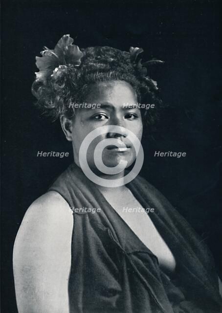 A Tongan woman, with scarlet hibiscus blossoms in her hair, 1902. Artist: JJ Lister.