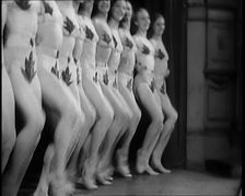 A Troupe of Dancers Wearing Fig Leaf Costumes Synchronised Dancing in Front of an Audience..., 1931. Creator: British Pathe Ltd