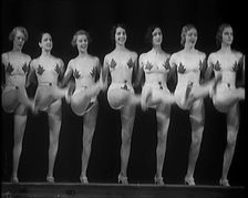 A Troupe of Dancers Wearing Fig Leaf Costumes Synchronised Dancing in Front of an Audience..., 1931. Creator: British Pathe Ltd