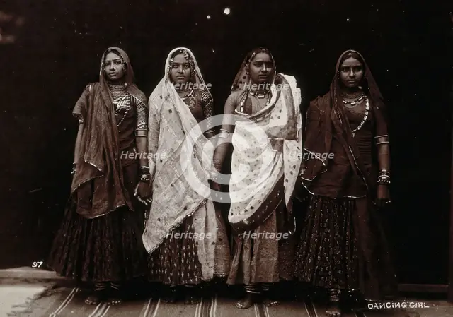 A troupe of nautch dancing girls, standing in a line holding hands, in a studio setting, c1900. Creator: Unknown.