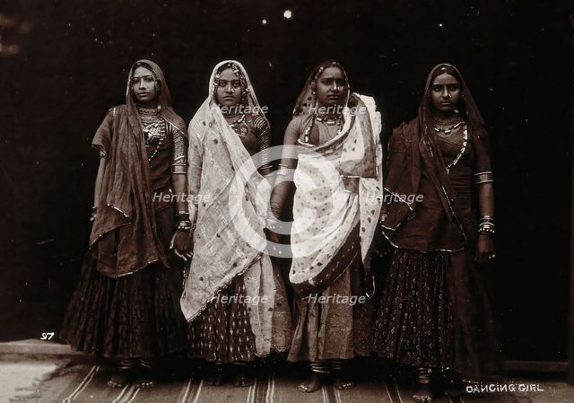 A troupe of nautch dancing girls, standing in a line holding hands, in a studio setting, c1900. Creator: Unknown.