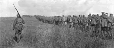 A travers le champ de bataille; colonne de prisonniers allemands diriges sur l'arriere..., 1918. Creator: Unknown