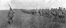 A travers le champ de bataille; colonne de prisonniers allemands diriges sur l'arriere..., 1918. Creator: Unknown