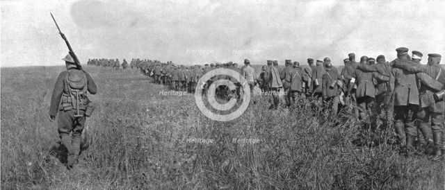 'A travers le champ de bataille; colonne de prisonniers allemands diriges sur l'arriere..., 1918. Creator: Unknown.