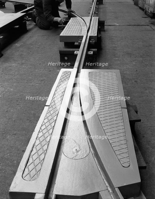 A trackwork junction being installed in a Sheffield factory, South Yorkshire, 1963. Creator: Michael Walters.