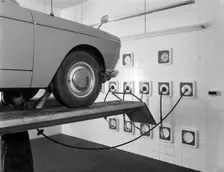 A traditional lubrication bay and mechanic at a garage, Sheffield, South Yorkshire, 1965. Creator: Michael Walters
