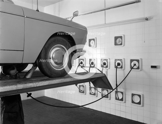 A traditional lubrication bay and mechanic at a garage, Sheffield, South Yorkshire, 1965. Artist: Michael Walters