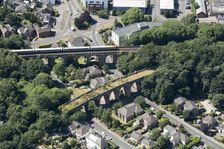 A train crossing a viaduct on the Poole and Bournemouth Railway, Poole, Dorset, 2018. Creator: Historic England