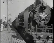 A Train Pulling Into a Station as Assorted Military Men Are Standing on the Platform, 1939. Creator: British Pathe Ltd