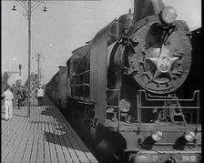 A Train Pulling Into a Station as Assorted Military Men Are Standing on the Platform, 1939. Creator: British Pathe Ltd